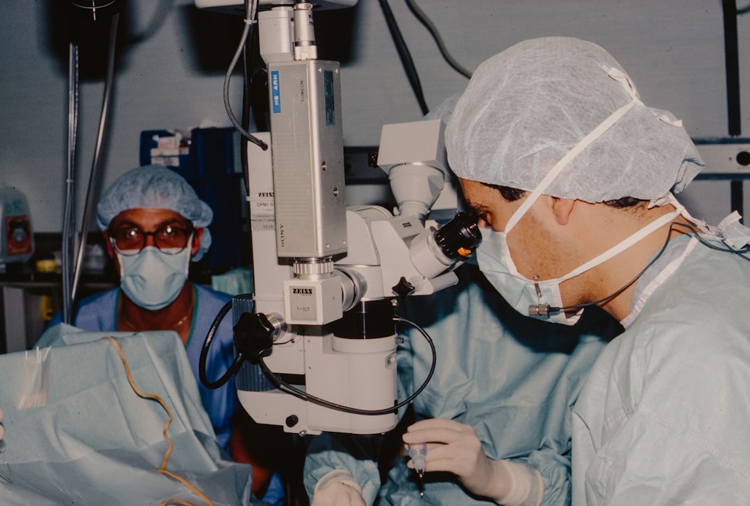 surgeons-operating-with-a-microscope-pge1vpdhn3o