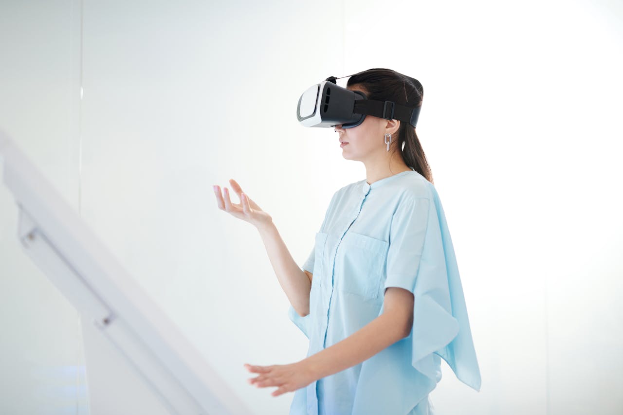 about-us Young woman engaged in virtual reality experience with a headset indoors.